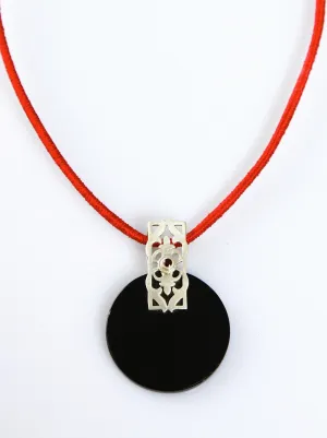 Beautiful, round black glass pendant with silver and garnet accent