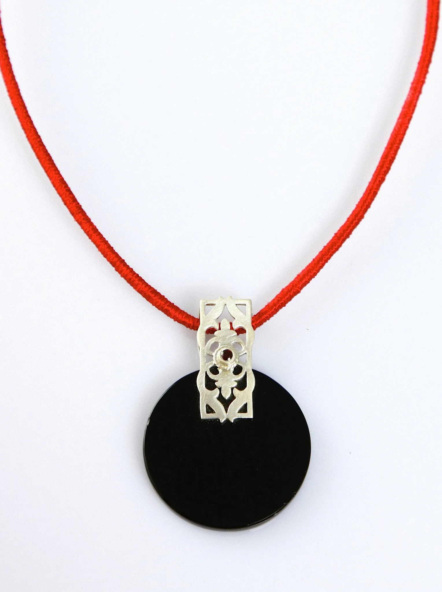 Beautiful, round black glass pendant with silver and garnet accent
